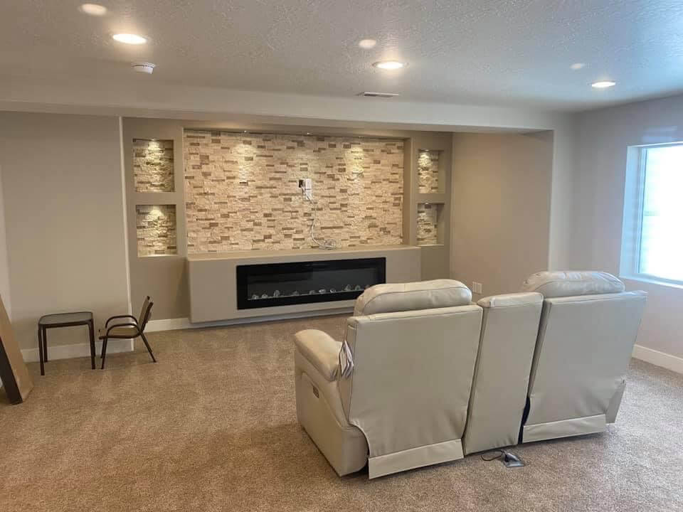 Inviting living room featuring fireplace and recliners, ideal for Utah Basement Finishing Theater Room Ideas