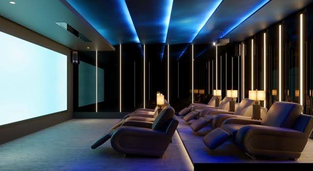 A modern home theater featuring plush reclining chairs and a large flat-screen display ready for immersive movie viewing