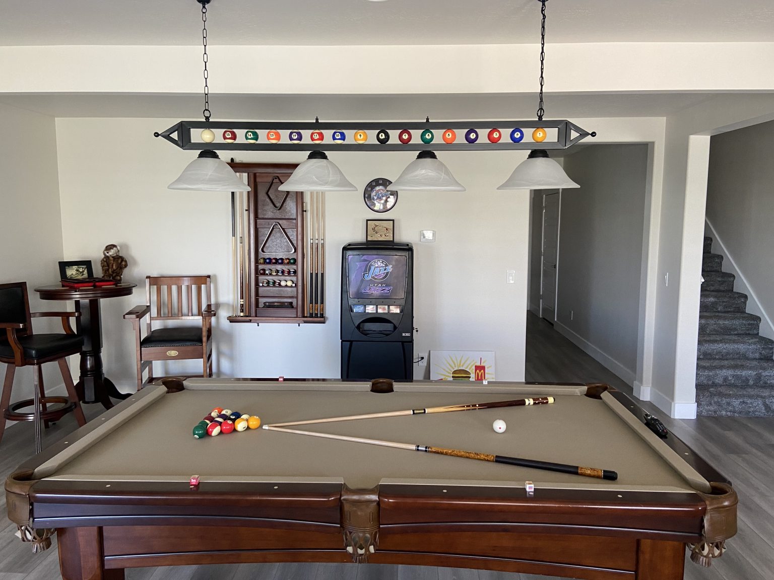 Living room with pool table, bar, and bar stool. Great for Basement Game Room Installers in Utah.