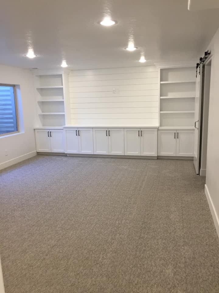 A clean room with white cabinets and a d