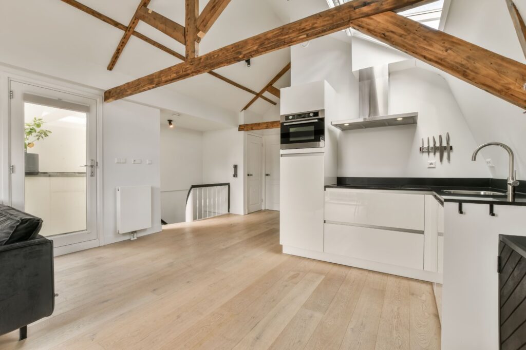 Kitchenette with wooden ceiling and sofa in basement renovation.