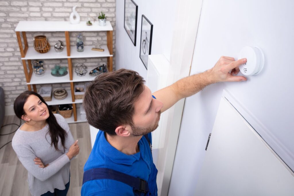 A man and woman stand before a white wall, discussing plans for a Utah basement apartment or mother-in-law suite.