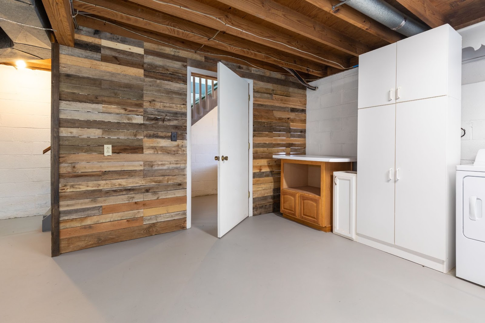 A well-organized laundry room in a Utah basement apartment featuring a washer and dryer for efficient laundry care.