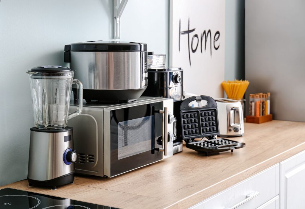 A tidy kitchen counter featuring a blender, coffee maker, and various culinary appliances