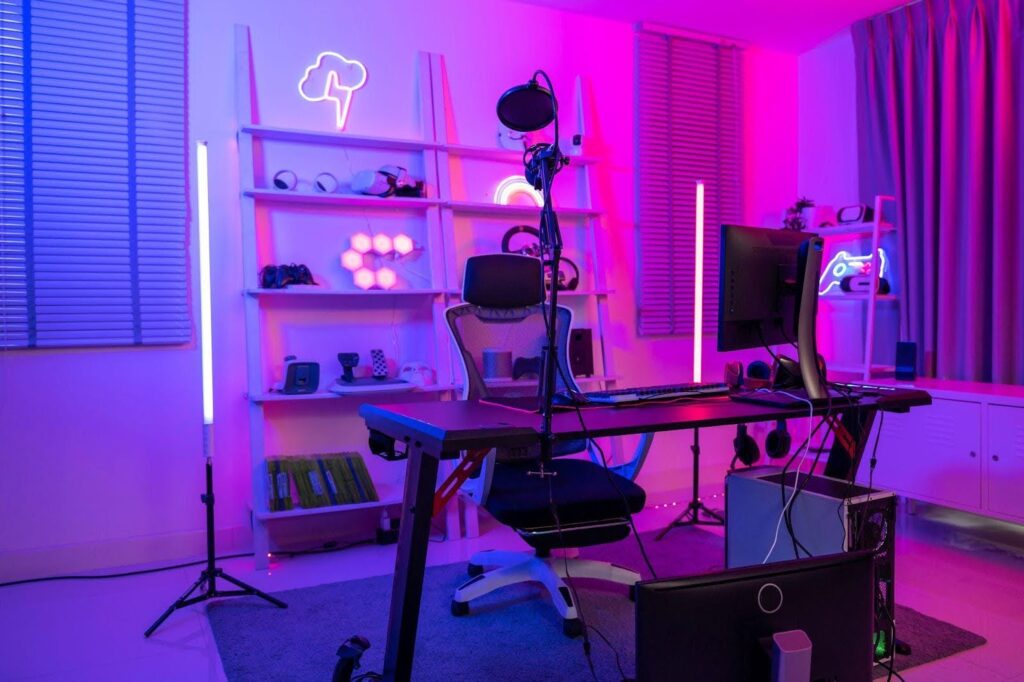 A room featuring a desk with a computer showcasing a workspace setup
