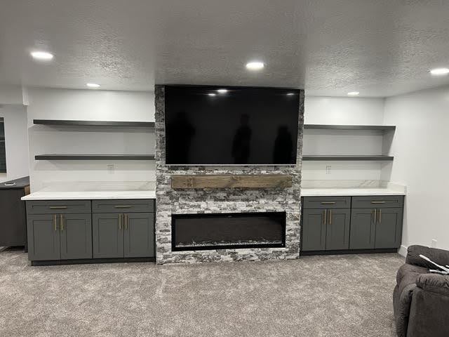 A cozy living room featuring a fireplace and a television creating a warm and inviting atmosphere